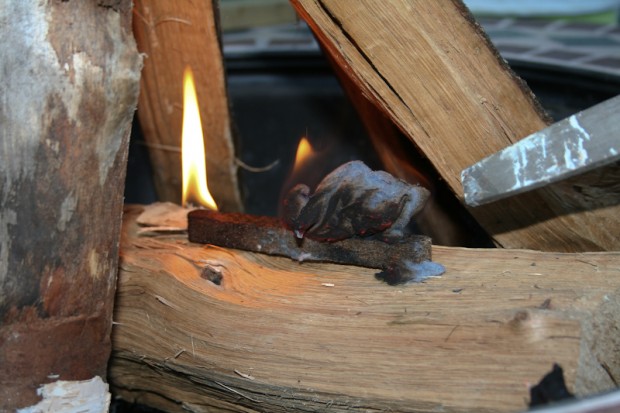 Since I didn't have twigs here, I'm using a commercially available fire starter to help the fire grow large enough to light the firewood.